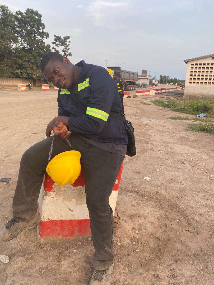 A factory worker sitting on highway reflector block