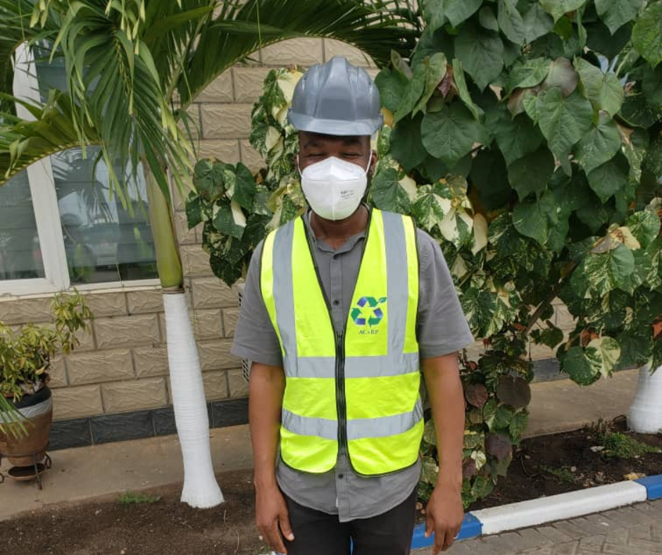 A man in a reflector working clothes with a helmet and nose mask