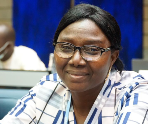 A woman in all smiles with a glasses on